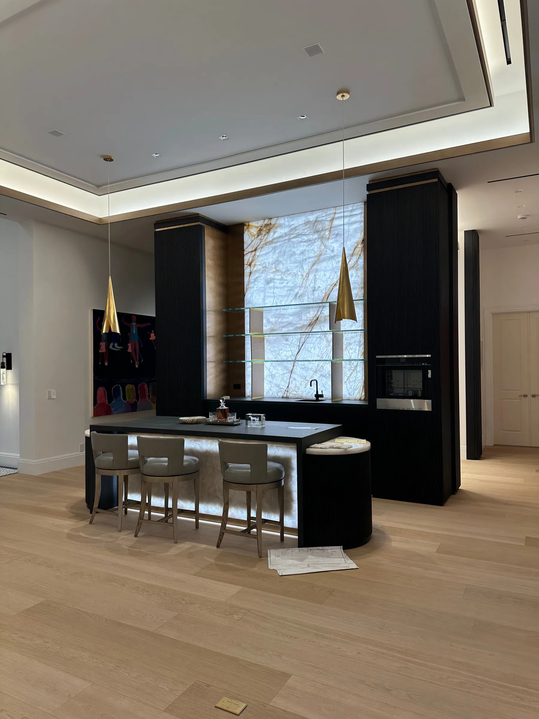 Custom home bar in black cabinetry with a backlit stone feature panel, Palm Beach County residence, Jupiter FL