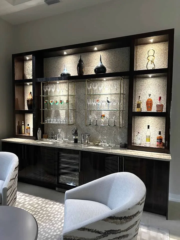 Custom bar in dark cabinetry with backlit display shelving and wine storage, Palm Beach County residence, Jupiter FL