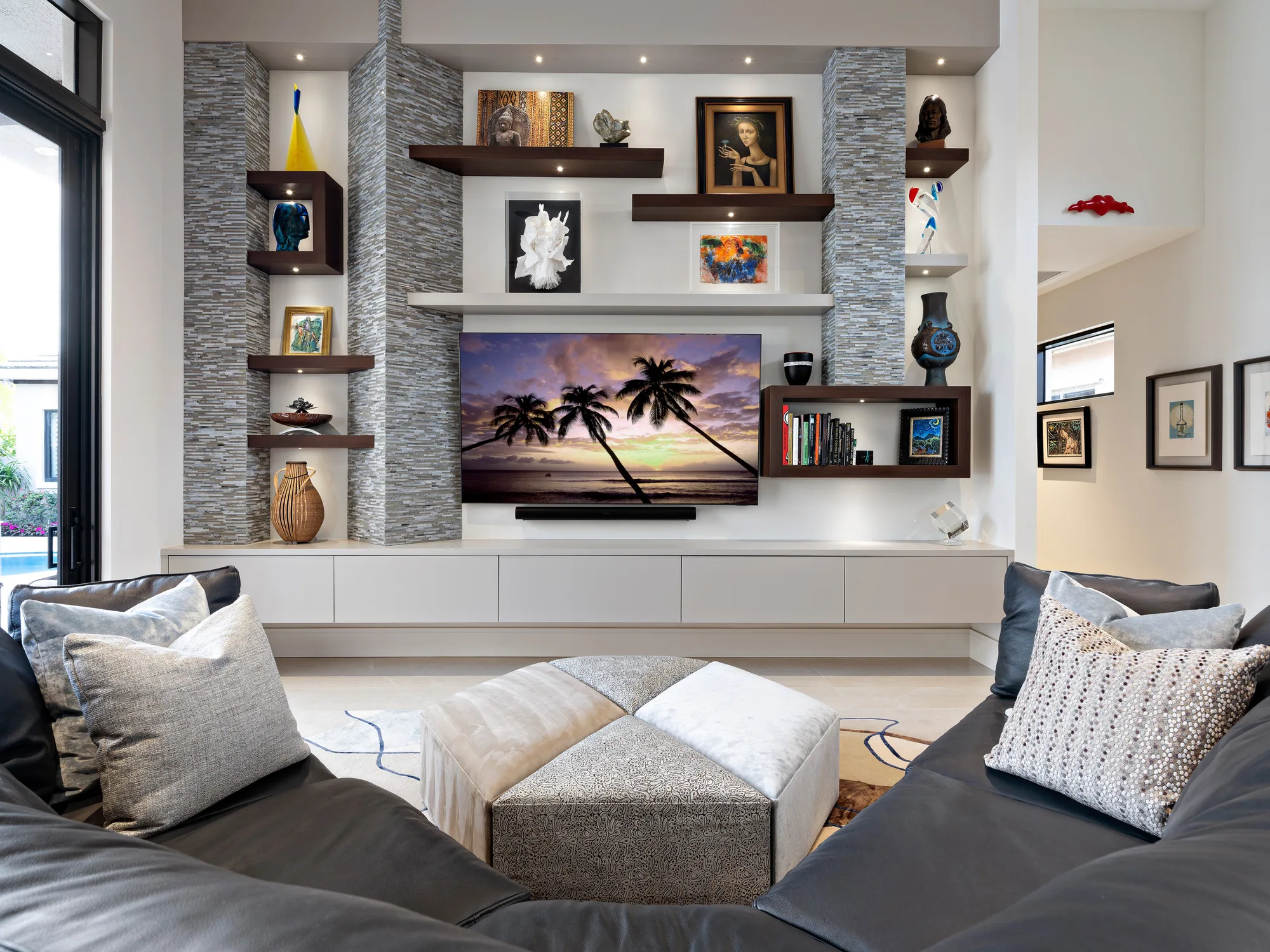 Custom media wall with floating walnut shelves and lit display niches, Palm Beach County residence, Jupiter FL