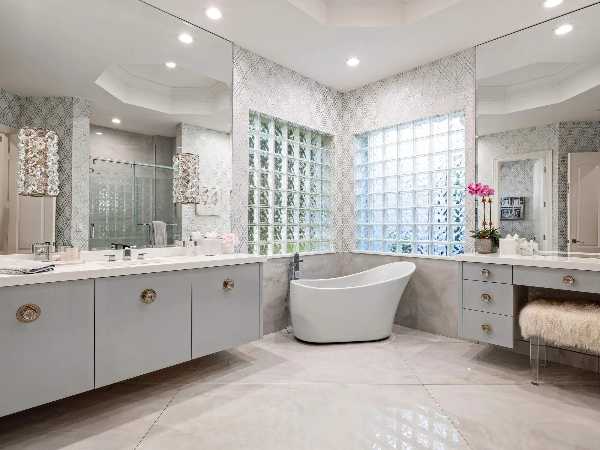 Custom primary bath vanity run in pale grey with a freestanding tub, Palm Beach County residence, Jupiter FL